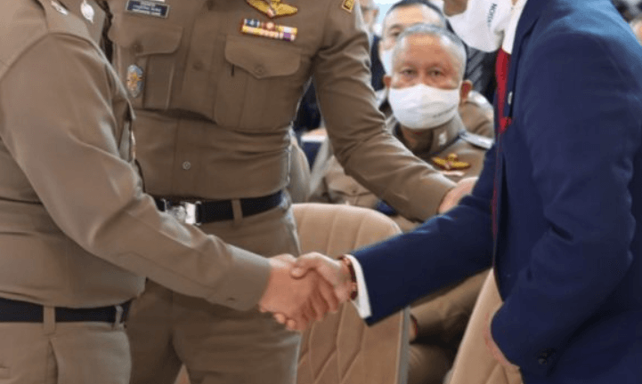A Leo Professional Consulting representative shaking hands with Thai immigration officers